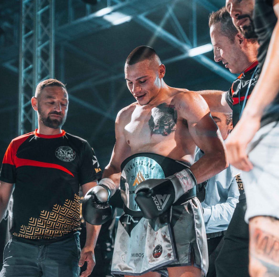Jesred Piscopo, Head Coach of Boom Combat Forge, wearing a championship title belt
